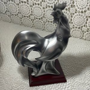 Roaster statue on wooden stand